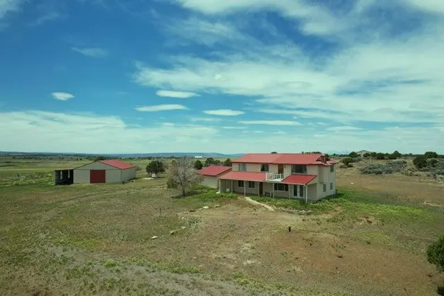 an aerial view of a house with a yard