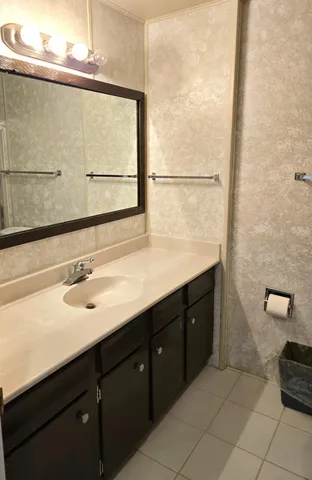 a bedroom with a bed dresser and a flat screen tv