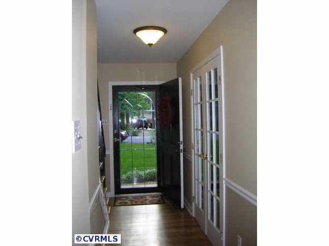 2001 Esquire Road Richmond, VA 23235 - Photo 5 of 10 a view of a hallway with wooden floor and a living room