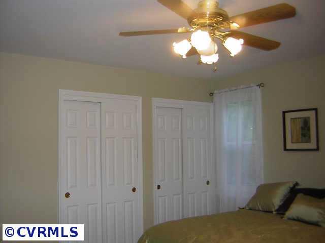 2001 Esquire Road Richmond, VA 23235 - Photo 7 of 10 a bedroom with a bed and a chandelier