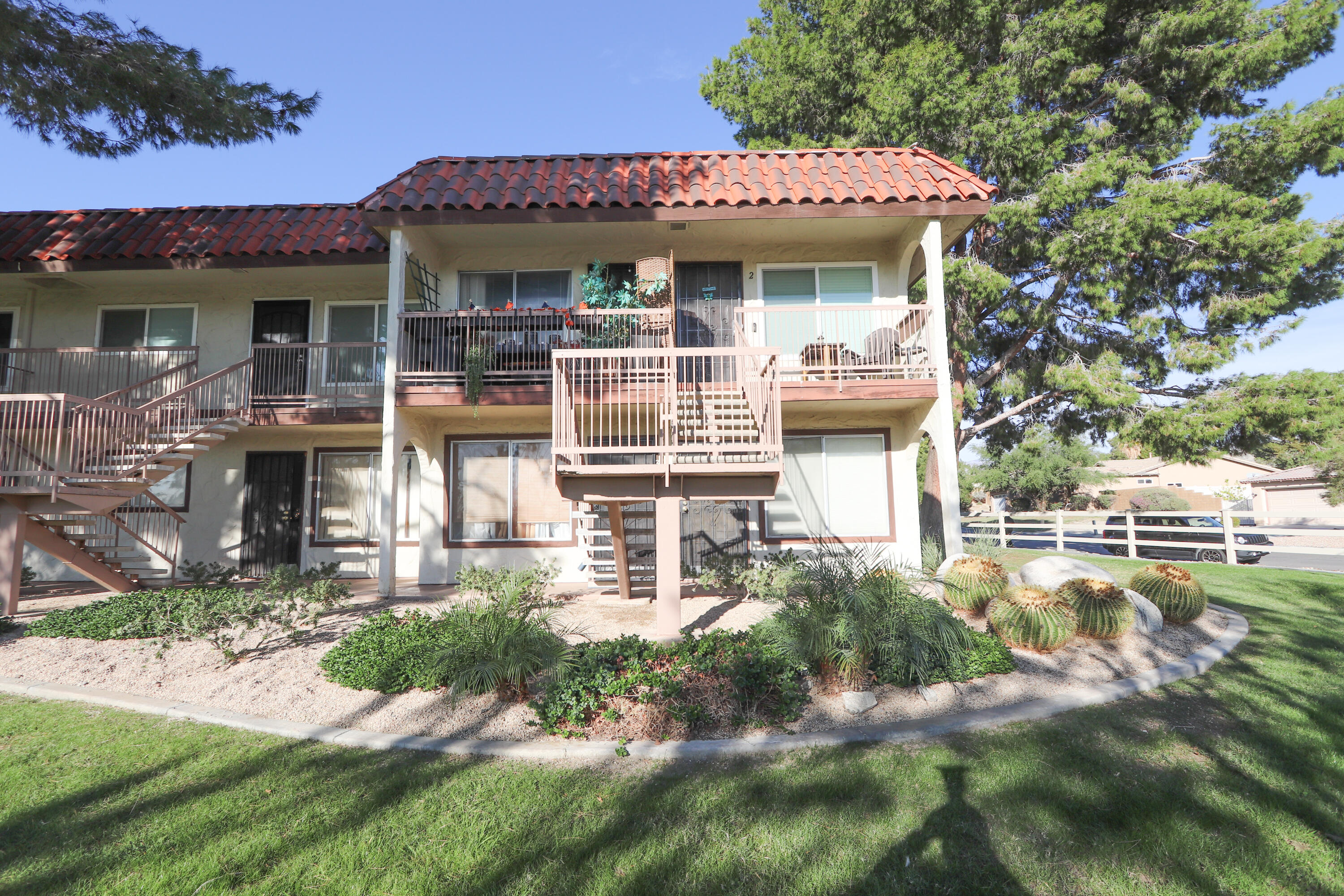 64291 Spyglass Avenue, Unit 2 Desert Hot Springs, CA 92240 - Photo 15 of 22 a front view of a house with a yard table and chairs