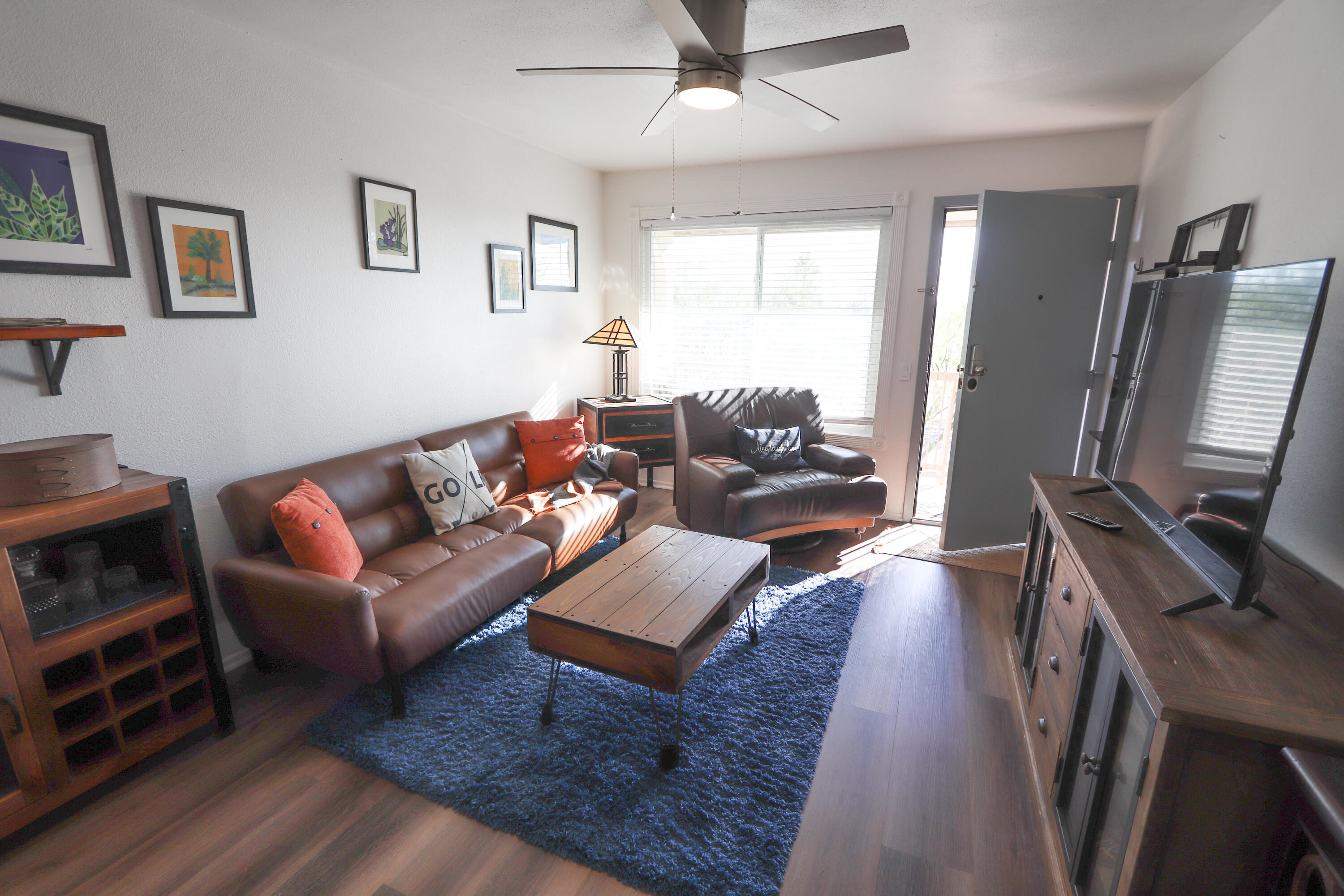 64291 Spyglass Avenue, Unit 2 Desert Hot Springs, CA 92240 - Photo 2 of 22 a living room with furniture flat screen tv and a couch