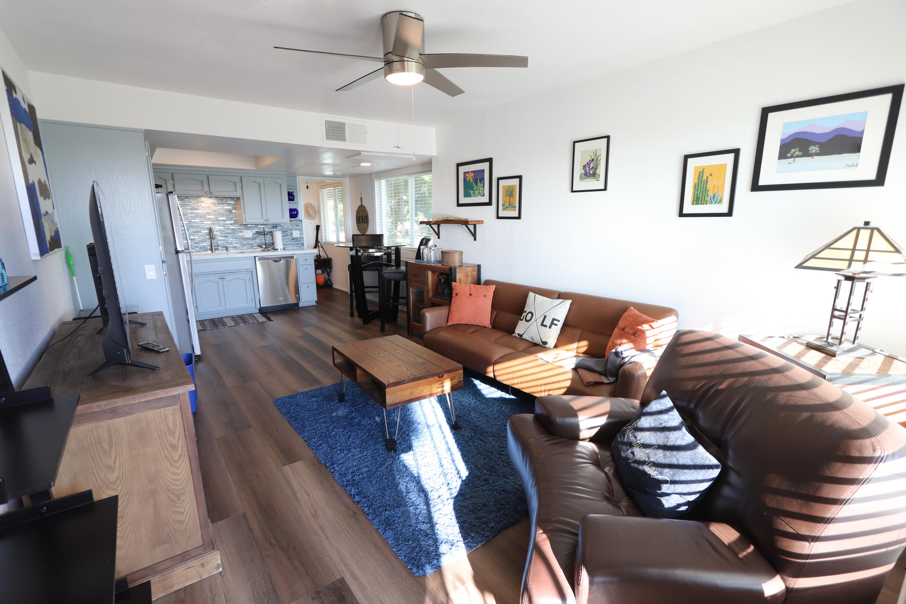 64291 Spyglass Avenue, Unit 2 Desert Hot Springs, CA 92240 - Photo 4 of 22 a living room with furniture kitchen view and a wooden floor