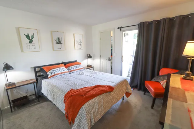 a bedroom with a bed and chair in it