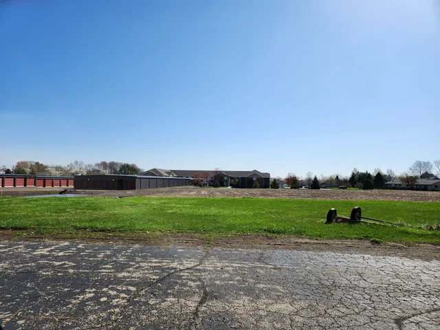 a view of outdoor space with field and trees