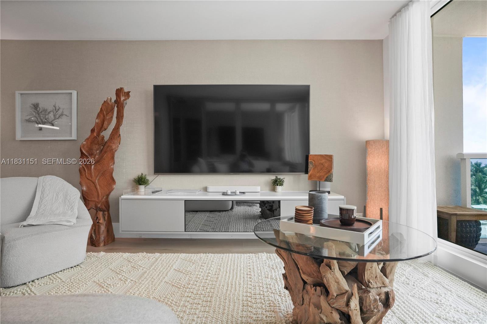2301 Collins Avenue, Unit 407 Miami Beach, FL 33139 - Photo 18 of 48 a living room with furniture and a flat screen tv