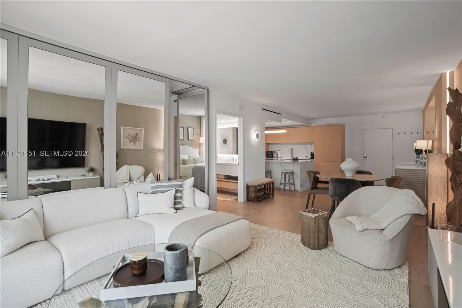 2301 Collins Avenue, Unit 407 Miami Beach, FL 33139 - Photo 20 of 48 a living room with furniture and a flat screen tv