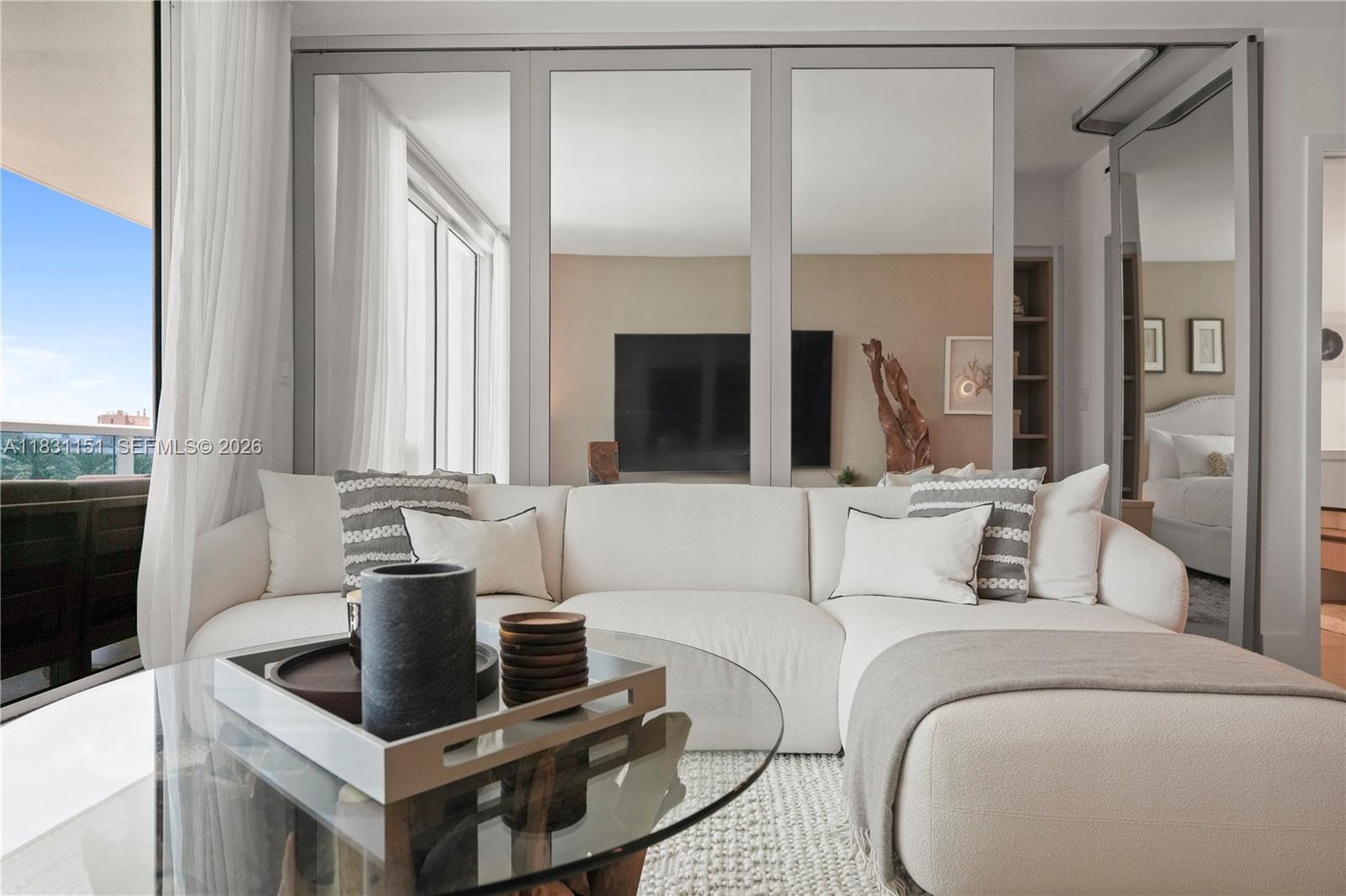 2301 Collins Avenue, Unit 407 Miami Beach, FL 33139 - Photo 21 of 48 a living room with furniture and a flat screen tv