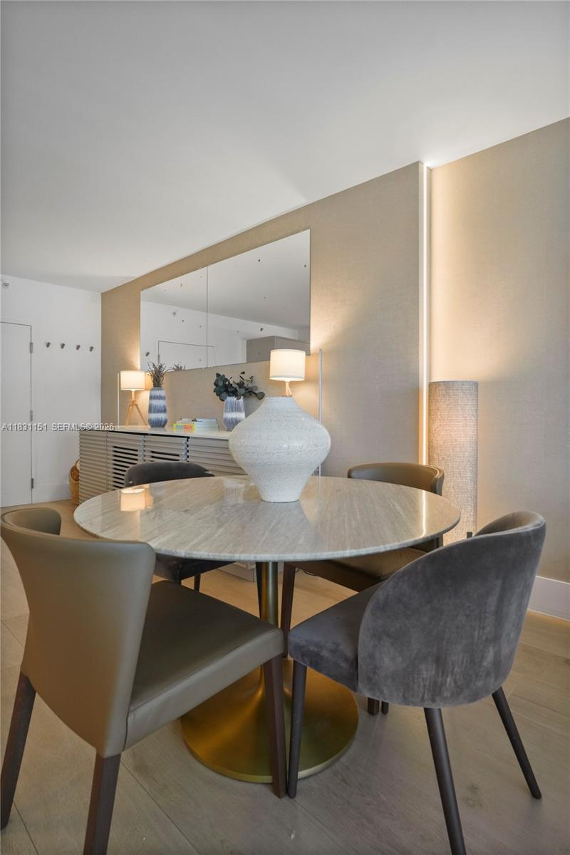 2301 Collins Avenue, Unit 407 Miami Beach, FL 33139 - Photo 24 of 48 a view of a dining room with furniture and wooden floor