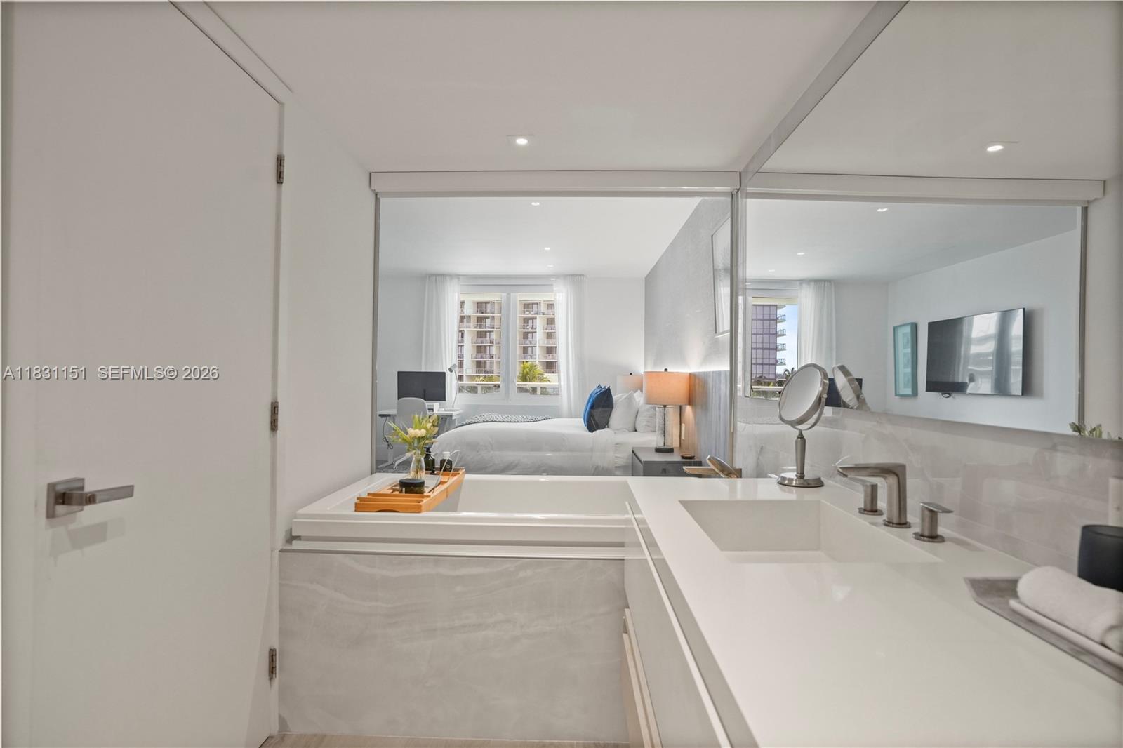 2301 Collins Avenue, Unit 407 Miami Beach, FL 33139 - Photo 30 of 48 a bathroom with a sink and a mirror