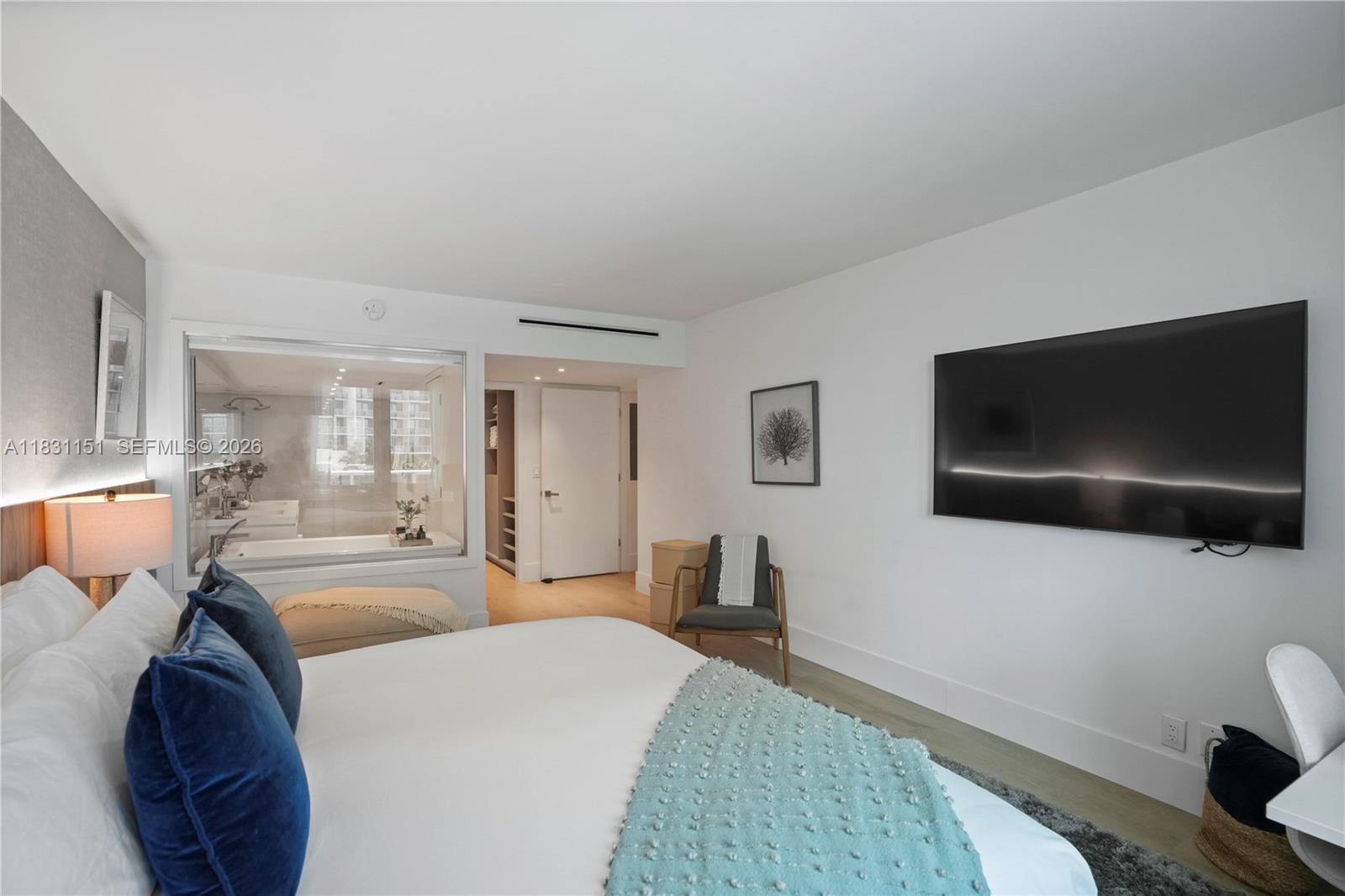 2301 Collins Avenue, Unit 407 Miami Beach, FL 33139 - Photo 35 of 48 a spacious bedroom with a bed and a flat screen tv