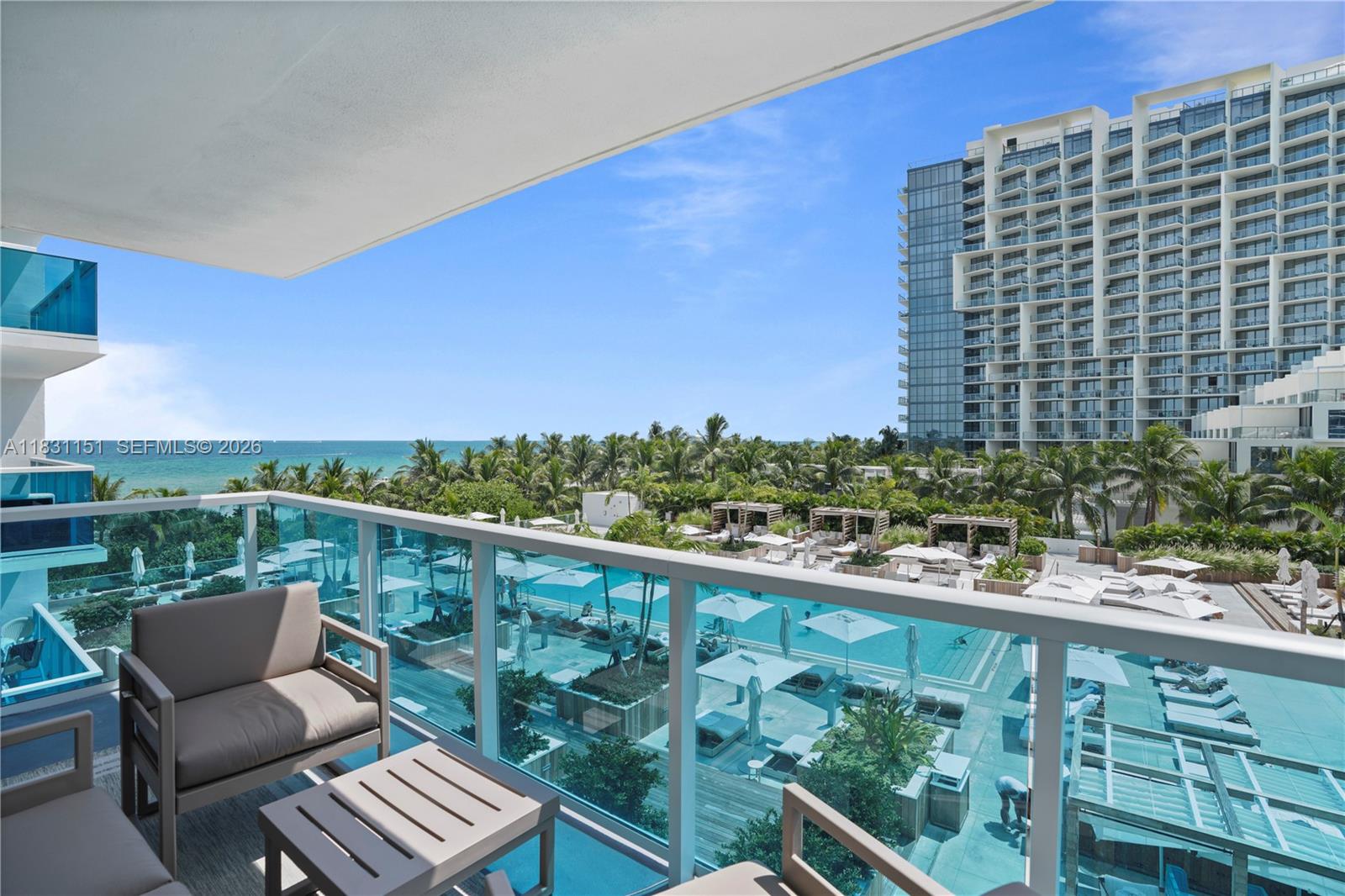 2301 Collins Avenue, Unit 407 Miami Beach, FL 33139 - Photo 43 of 48 a view of a balcony with wooden chairs