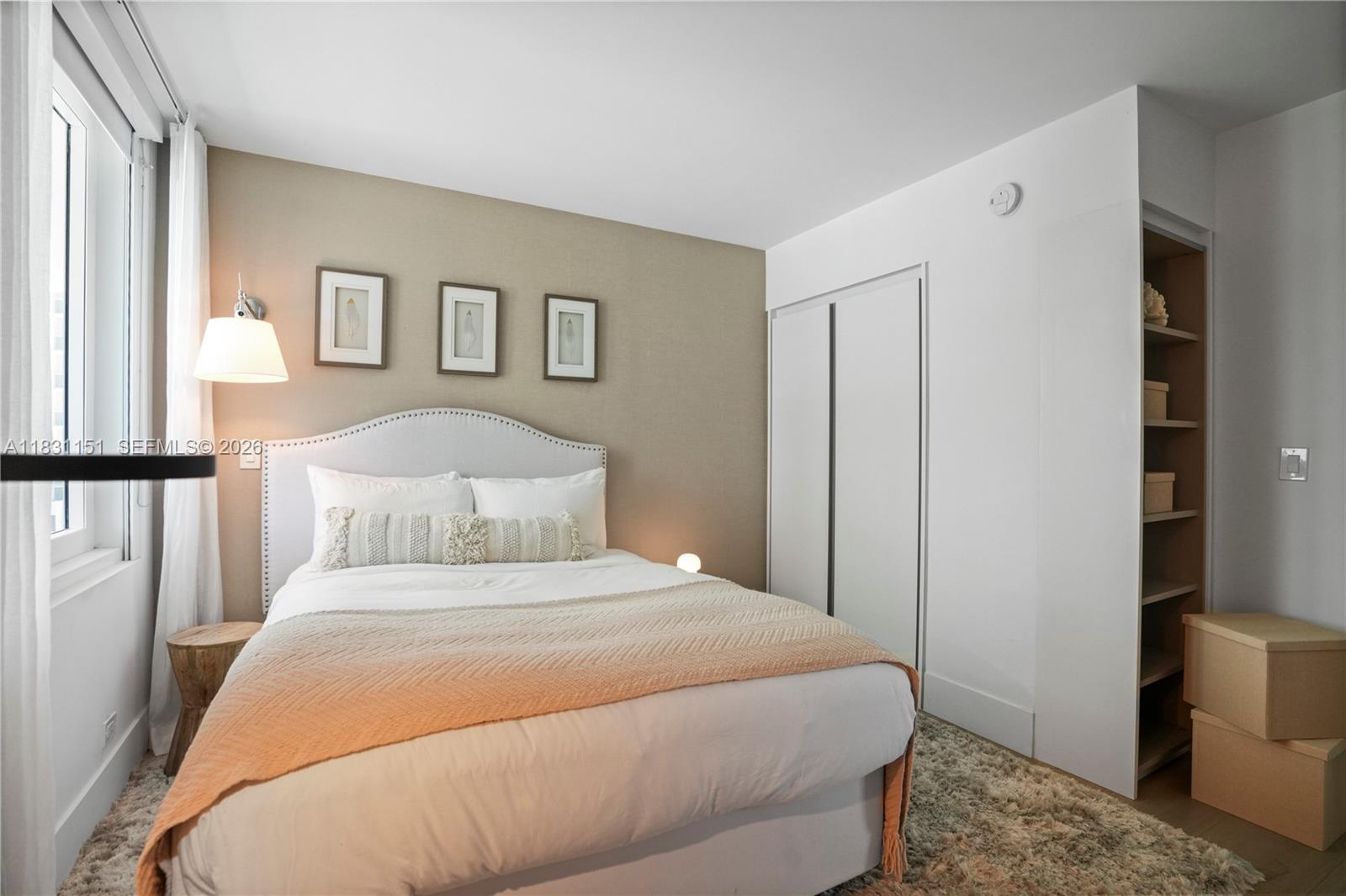 2301 Collins Avenue, Unit 407 Miami Beach, FL 33139 - Photo 5 of 48 a bedroom with a bed and a painting on the wall