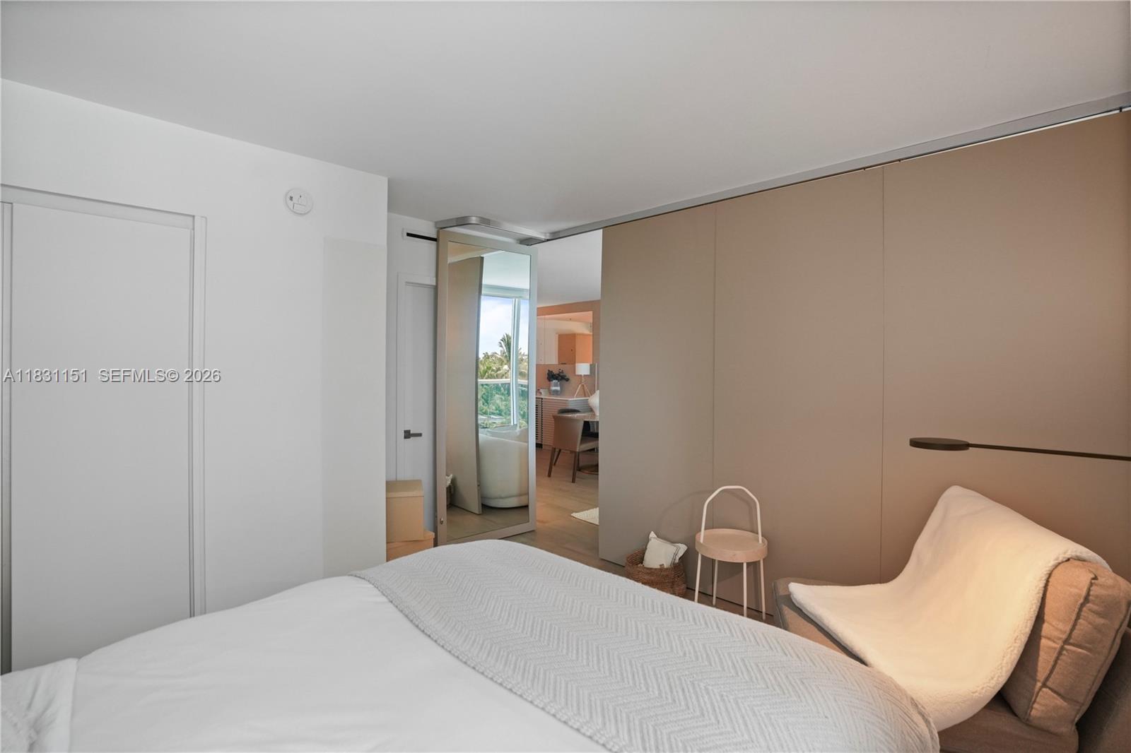 2301 Collins Avenue, Unit 407 Miami Beach, FL 33139 - Photo 6 of 48 a bedroom with a bed and a chair