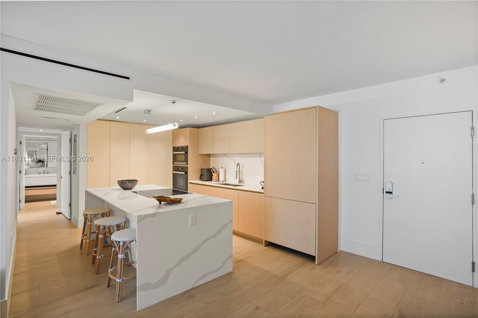 2301 Collins Avenue, Unit 407 Miami Beach, FL 33139 - Photo 8 of 48 a kitchen with stainless steel appliances a refrigerator and a stove top oven
