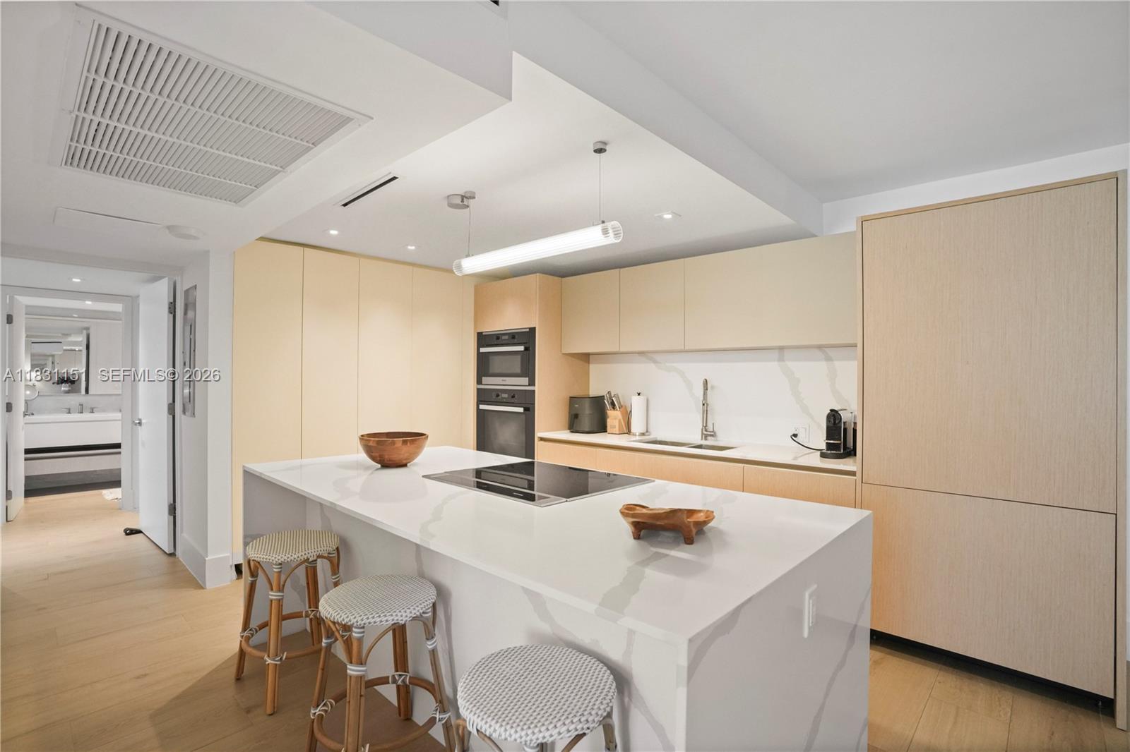 2301 Collins Avenue, Unit 407 Miami Beach, FL 33139 - Photo 9 of 48 a room with a table chairs and a refrigerator