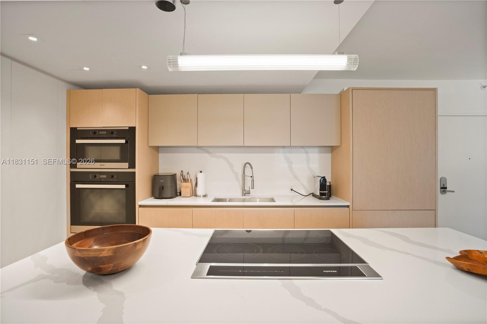 2301 Collins Avenue, Unit 407 Miami Beach, FL 33139 - Photo 10 of 48 a kitchen with a sink and a stove