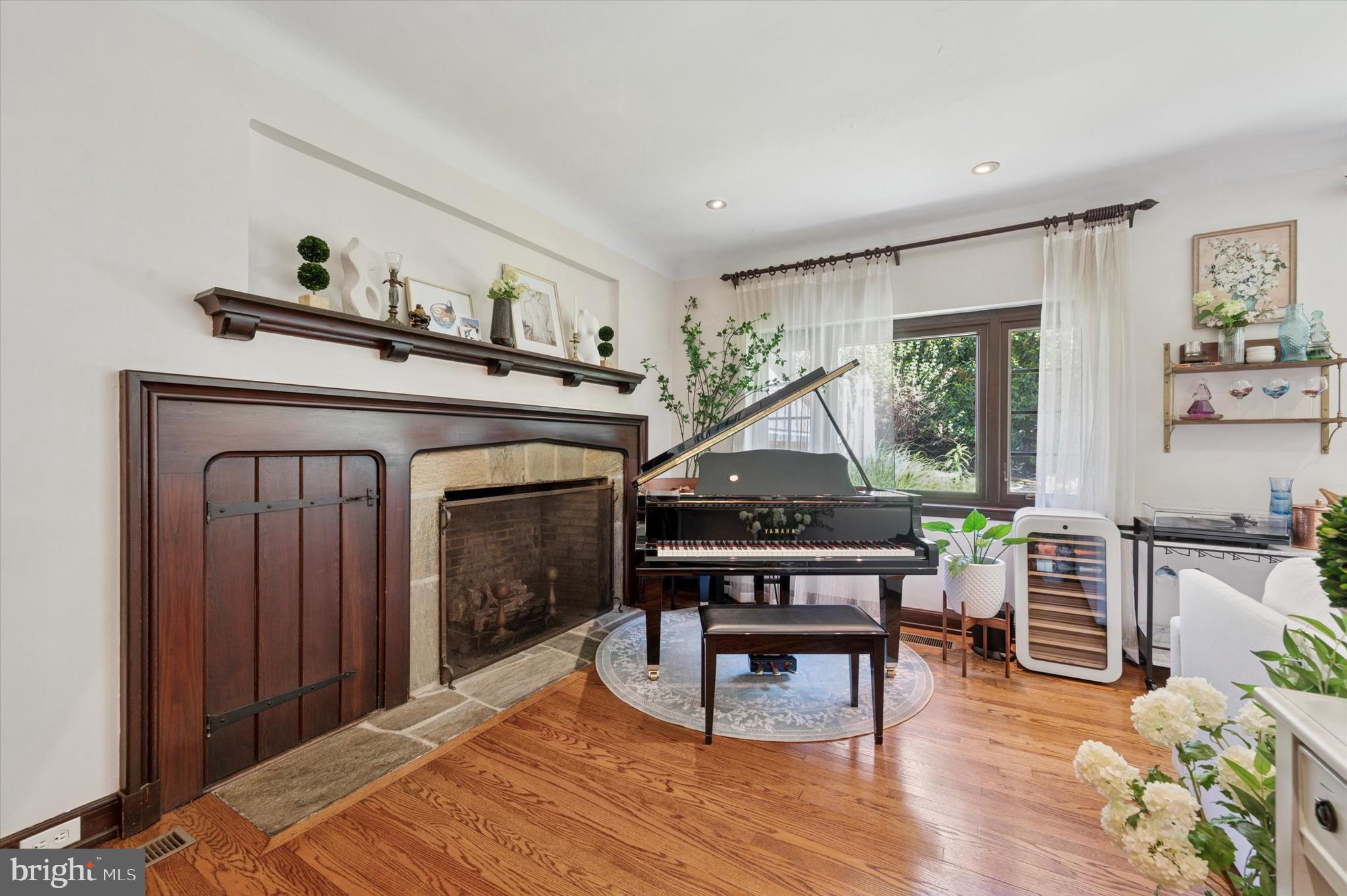 211 Ladbroke Road Bryn Mawr, PA 19010 - Photo 19 of 38 a living room with furniture a fireplace and a table