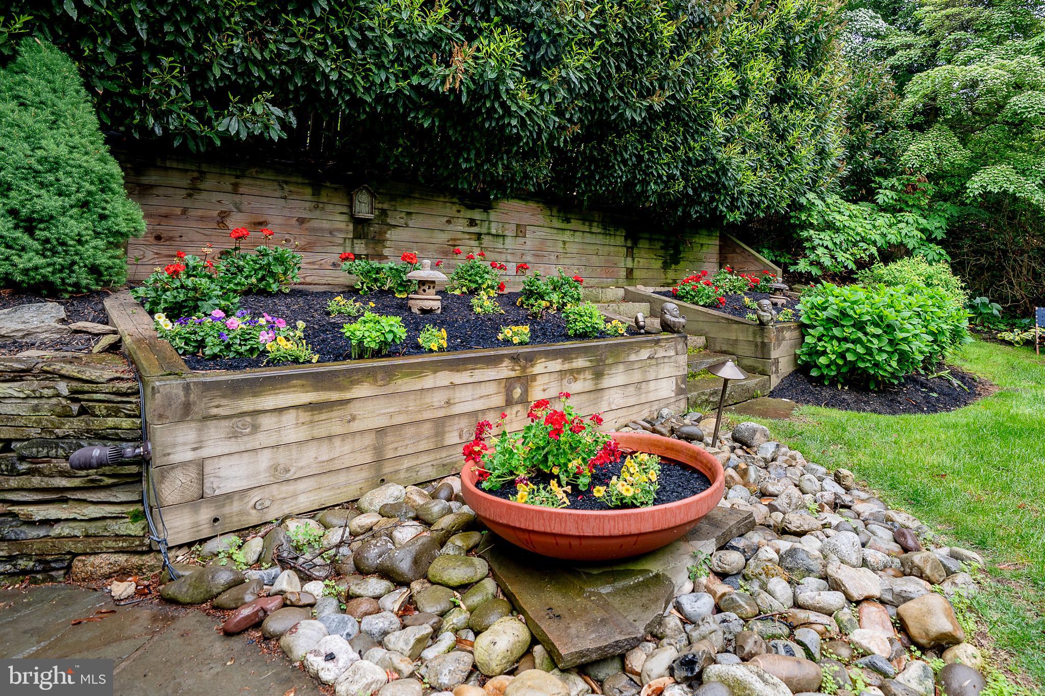 211 Ladbroke Road Bryn Mawr, PA 19010 - Photo 37 of 38 a view of a backyard with potted plants