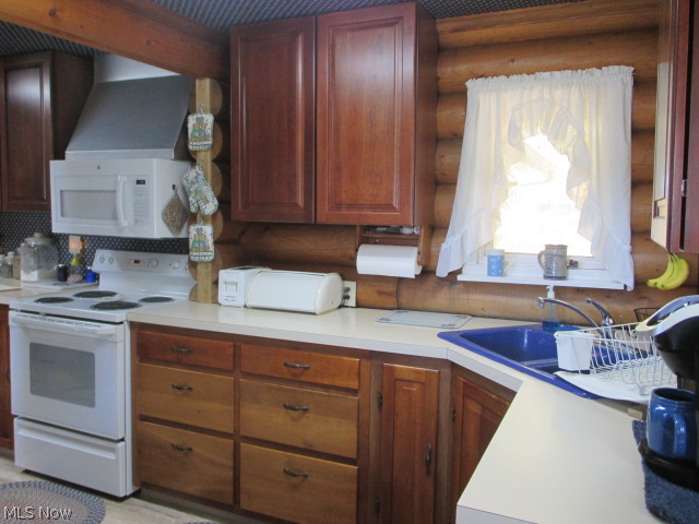 16920 Heiser Road Berlin Center, OH 44401 - Photo 5 of 25 Your efficient kitchen features cherry cabinets, new vinyl floor offering plenty of storage with a spacious pantry offering all appliances for your convience