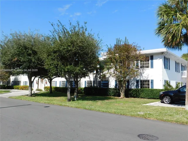 a house with palm tree in front of it