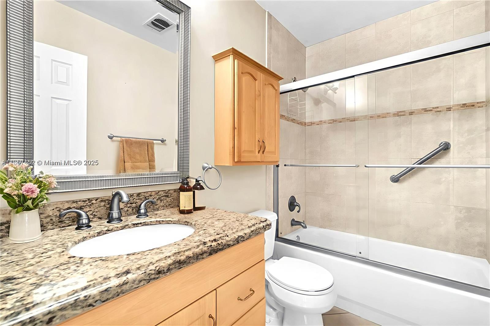 2171 Northeast 66th Street, Unit 801 Fort Lauderdale, FL 33308 - Photo 11 of 31 a bathroom with a granite countertop sink a toilet and shower