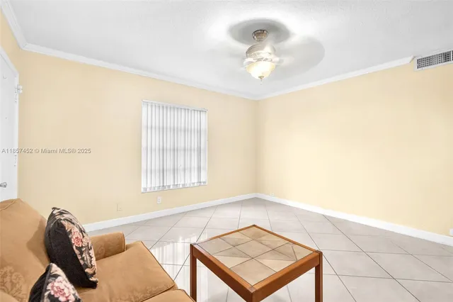 a living room with a bed furniture and a window