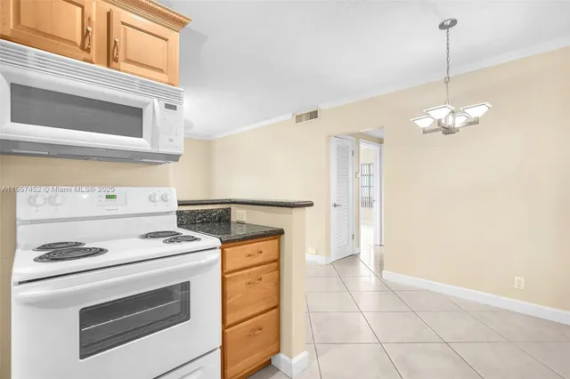 a kitchen with a stove oven and white cabinets