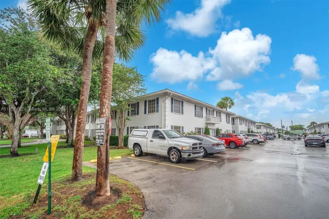 a car parked in front of white house