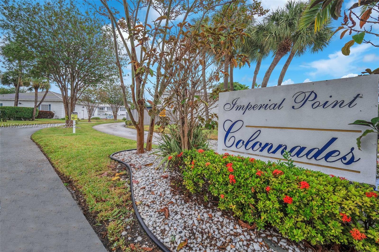 2171 Northeast 66th Street, Unit 801 Fort Lauderdale, FL 33308 - Photo 27 of 31 a sign that is sitting in front of flowers