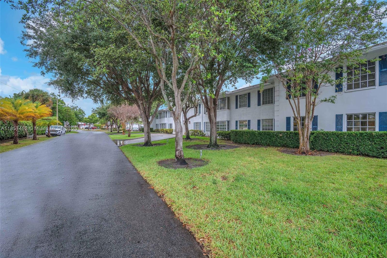 2171 Northeast 66th Street, Unit 801 Fort Lauderdale, FL 33308 - Photo 31 of 31 a view of a house with a big yard and large trees