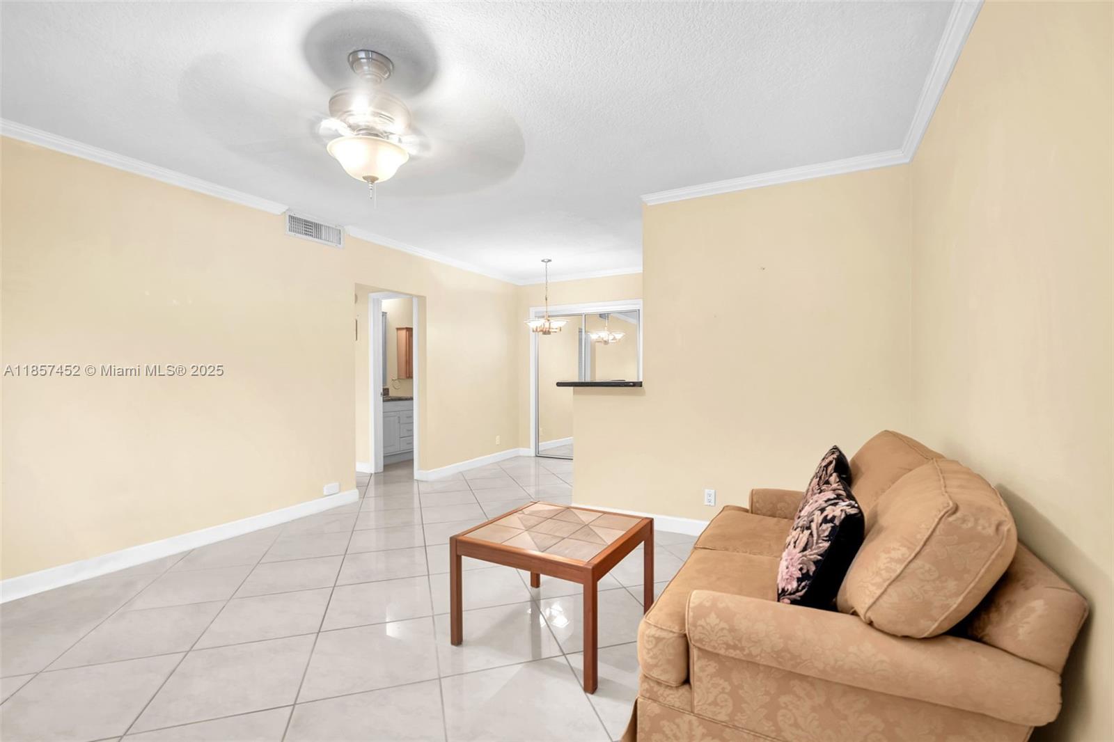 2171 Northeast 66th Street, Unit 801 Fort Lauderdale, FL 33308 - Photo 10 of 31 a living room with furniture and a chandelier