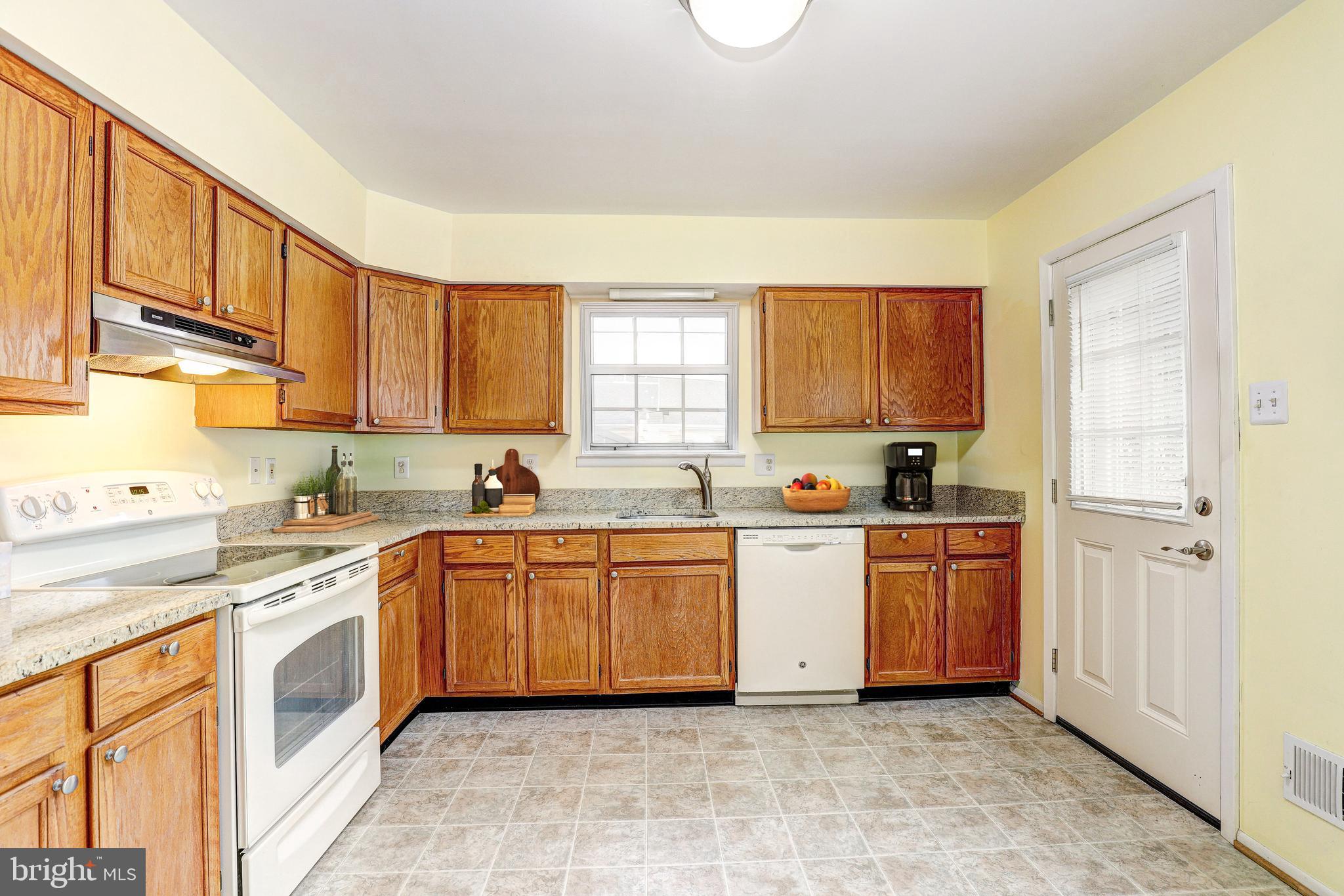 5669 Crabapple Drive Frederick, MD 21703 - Photo 6 of 24 a large kitchen with stainless steel appliances granite countertop a stove sink and cabinets