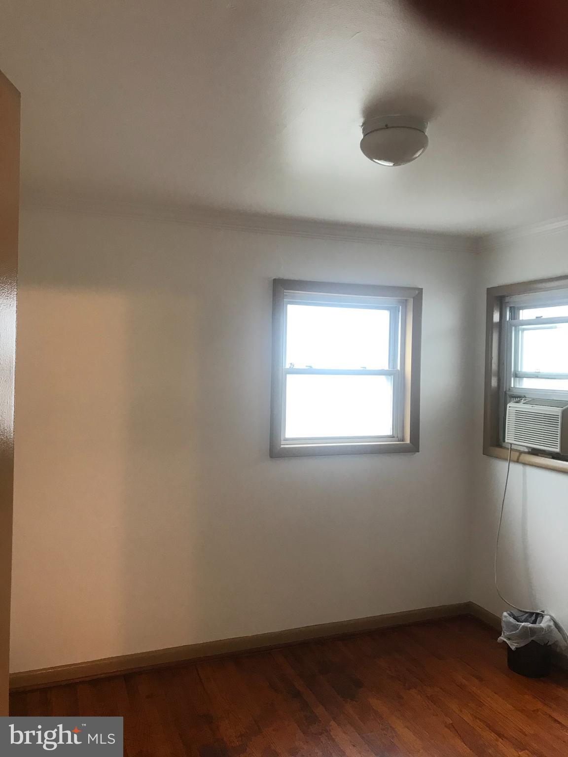 5920 Greentree Road Bethesda, MD 20817 - Photo 12 of 21 an empty room with wooden floor and windows