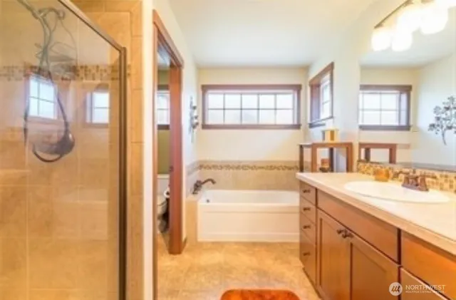 a bathroom with a tub sink and mirror
