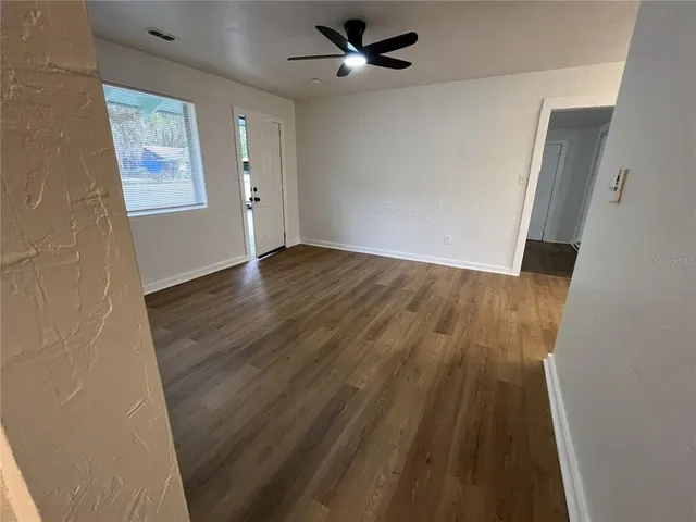 wooden floor in an empty room with a window