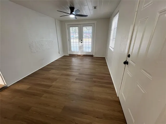 wooden floor in an empty room with a window