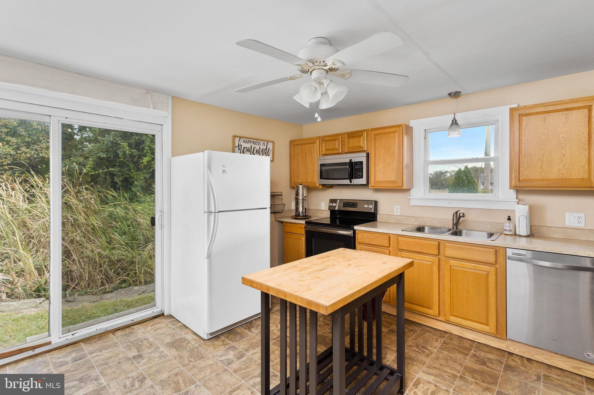 418 Jacobstown Cookstown Road Wrightstown, NJ 08562 - Photo 13 of 30 a kitchen with a refrigerator a sink dishwasher a stove and a refrigerator with wooden floor