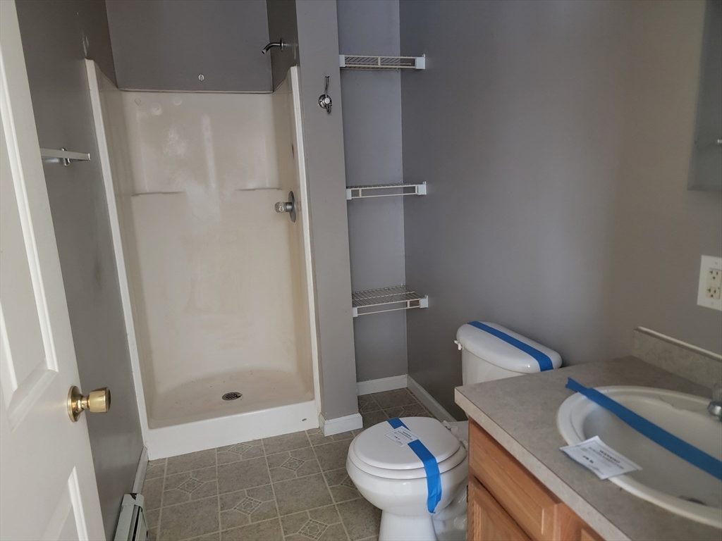 524 South Main Street Orange, MA 01364 - Photo 11 of 19 a bathroom with a granite countertop sink toilet and shower