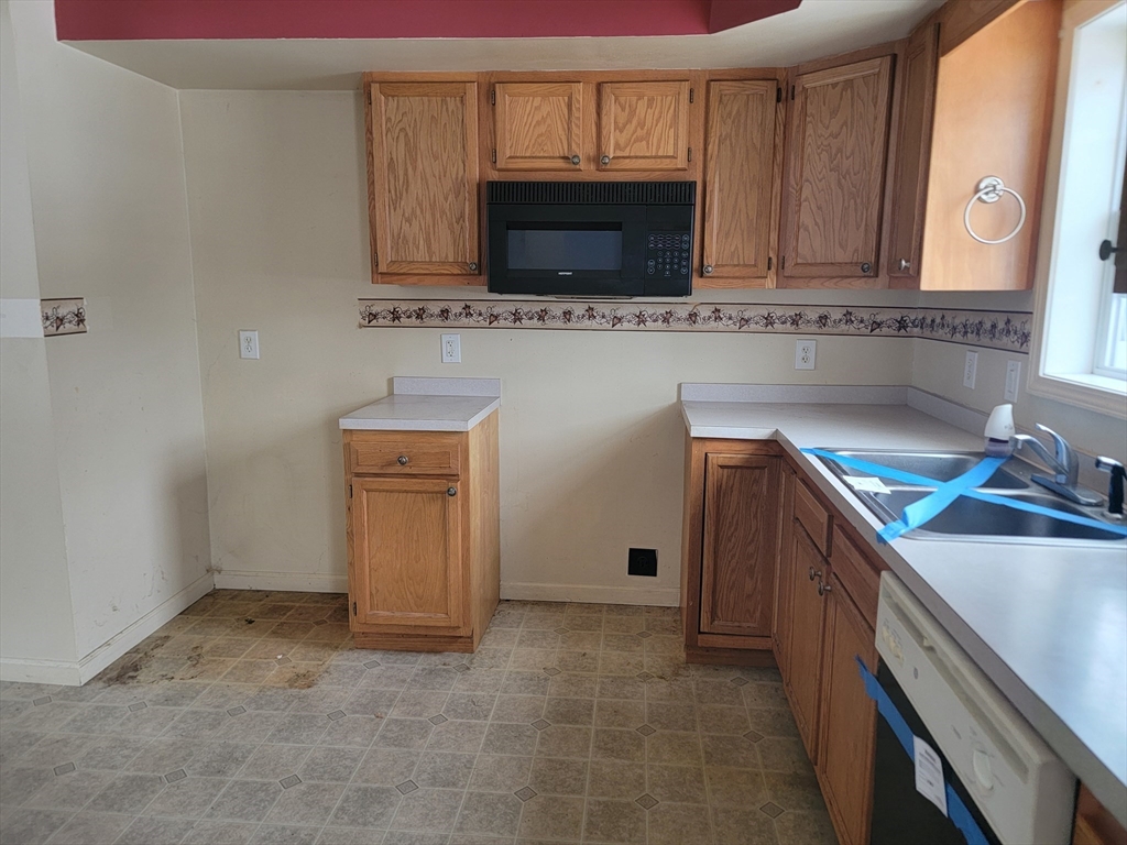524 South Main Street Orange, MA 01364 - Photo 6 of 19 a kitchen with a sink and a microwave