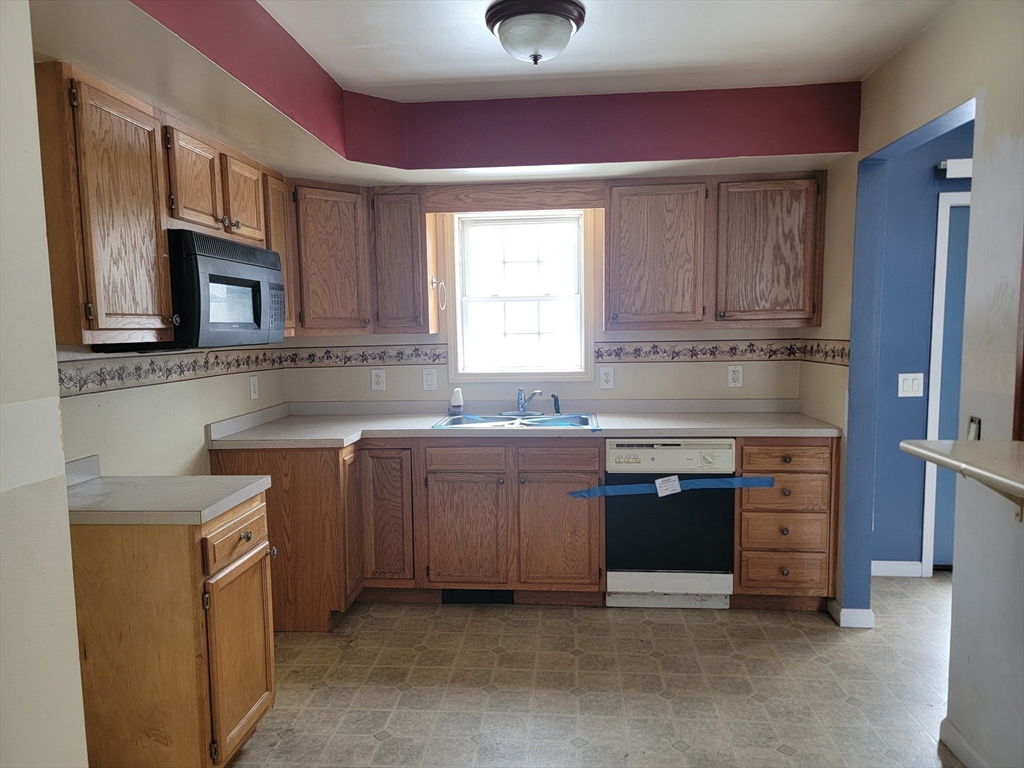 524 South Main Street Orange, MA 01364 - Photo 7 of 19 a kitchen with stainless steel appliances granite countertop a sink stove and refrigerator