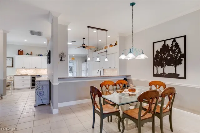 a dinning area with stainless steel appliances kitchen island granite countertop a table and chairs