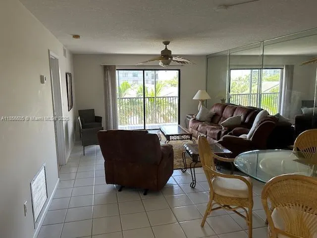 a kitchen with granite countertop a refrigerator a stove a sink dishwasher and wooden cabinets with wooden floor