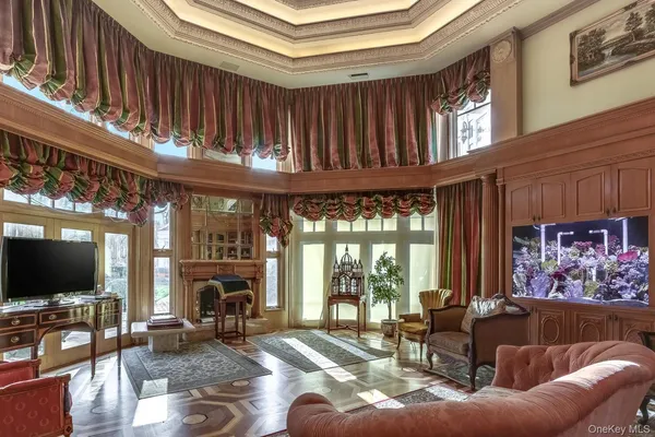 a living room with furniture a large window and a flat screen tv