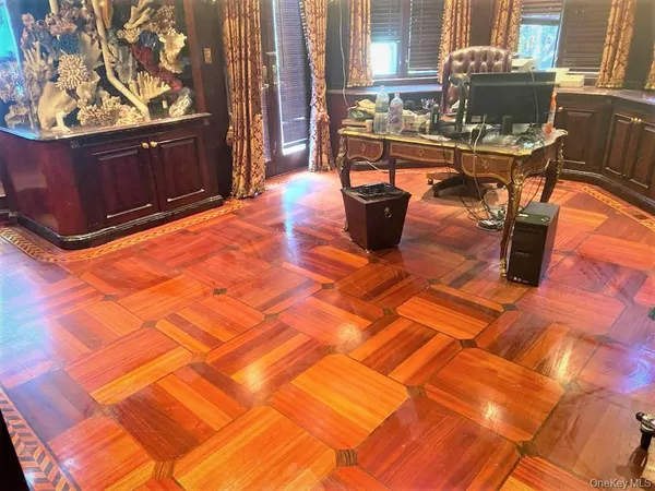 a living room with couches chairs and wooden floor