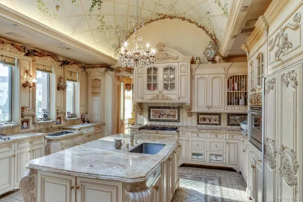 a kitchen with stainless steel appliances granite countertop a sink and cabinets