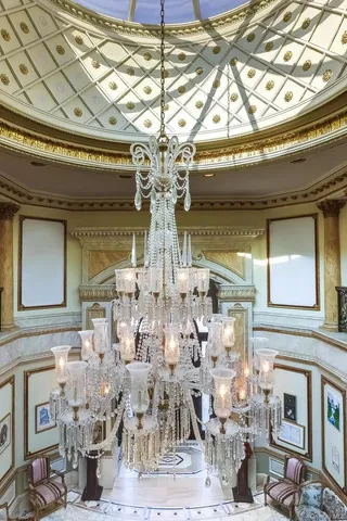 a spacious bedroom with a bed and a flat screen tv