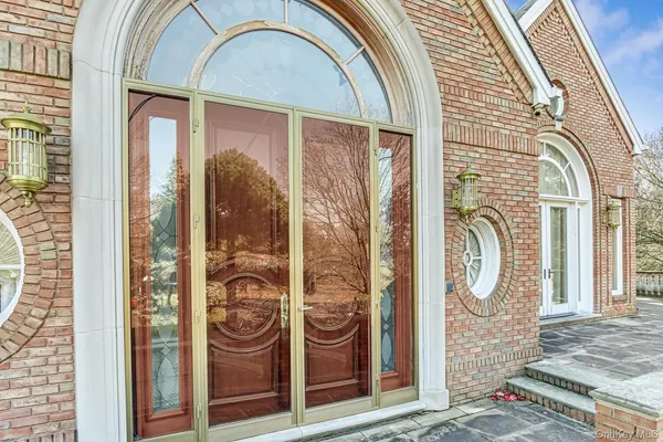 a front view of a house with a fountain