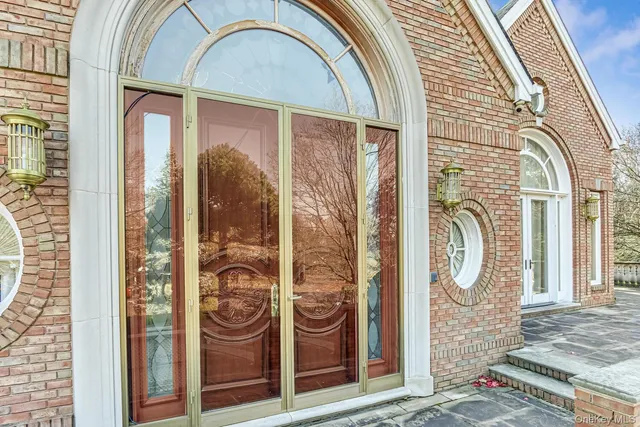 a front view of a house with a fountain