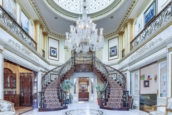 a large building with a clock on the balcony